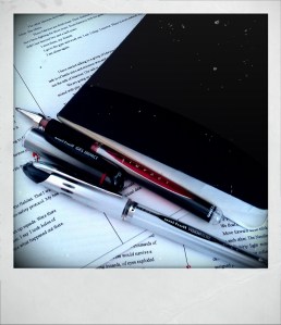 My writing materials Moleskine notebook and Uniball gel pens